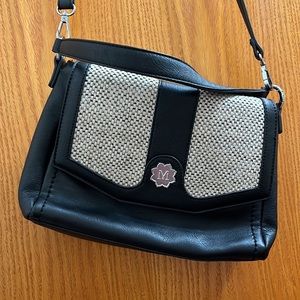 Brand new black and oatmeal-colored woven Magnolia and Vine purse.